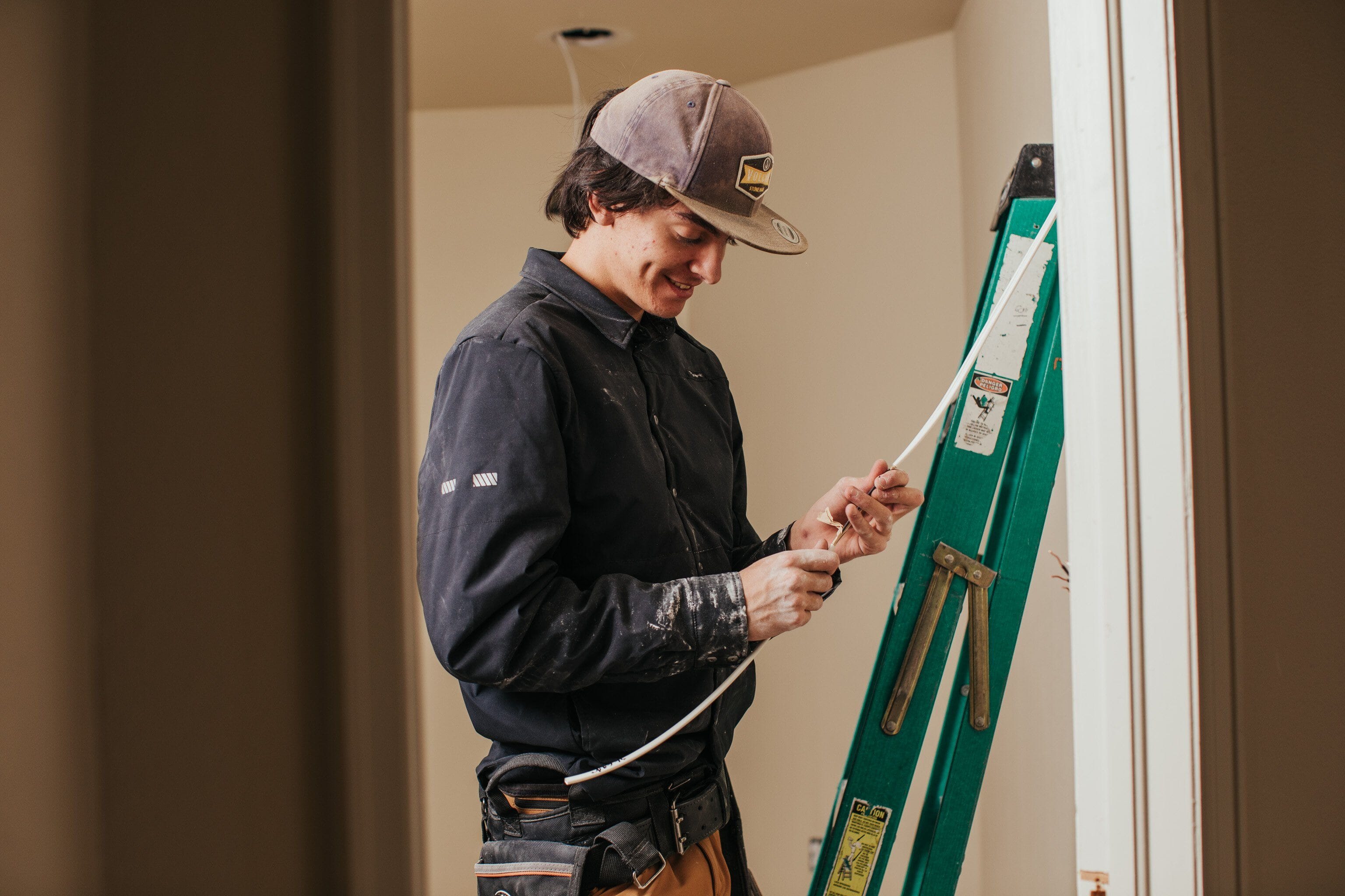 A painter wears Truewerk workwear as he works on a job site.